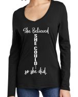 Woman wearing a black women's fit tri-blend long sleeve v-neck t-shirt with the She Believed She Could design on the front.